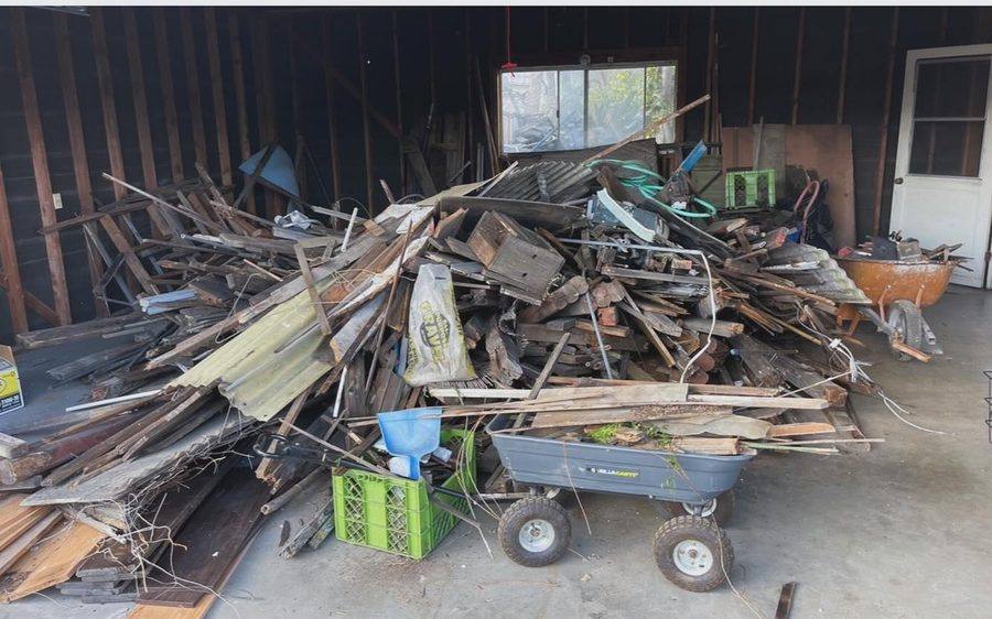 Garage piled with construction lumber before removal